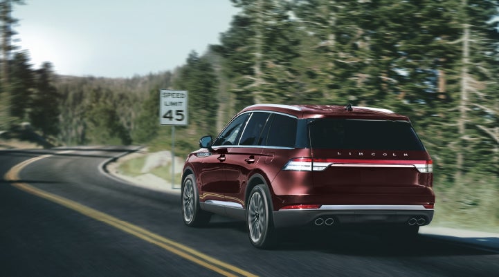 A 2024 Lincoln Aviator® SUV is being driven on a winding mountain road | Preston Lincoln in Hurlock MD