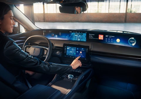 The driver of a 2024 Lincoln Nautilus® SUV interacts with the center touchscreen. | Preston Lincoln in Hurlock MD